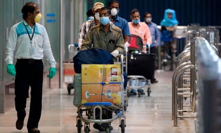 Indian citizens evacuated from Dubai on Air India flights arrive at Chennai airport.