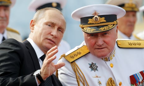 Vladimir Putin with Russian naval chief admiral Vladimir Korolev at a naval parade in St Petersburg on Sunday.