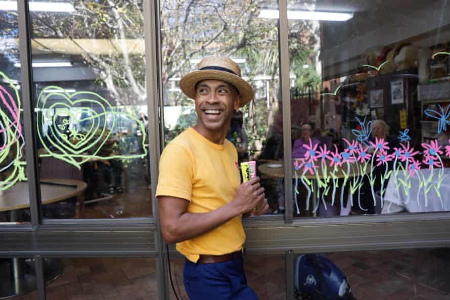 Musician and actor Benhur Helwend creating window art at the Whiddon aged care home in Sydney’s north shore.