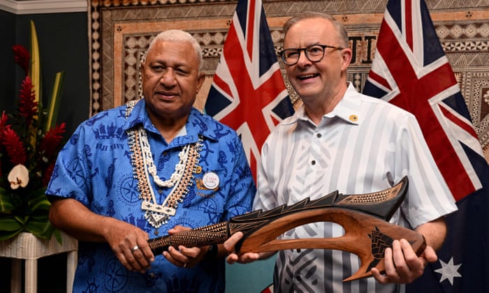 Fiji PM Frank Bainimarama presents Anthony Albanese with a Wau war club