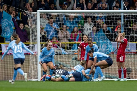 Manchester City begin the celebrations after Rebecca Knaak’s late winner against Liverpool on Sunday