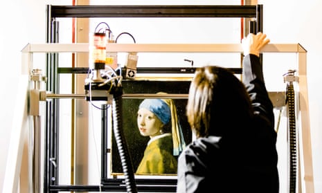 A researcher at the Mauritshuis gallery in The Hague places Johannes Vermeer’s Girl with a Pearl Earring inside a scanner. 