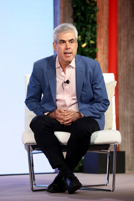 man speaks while seated on stage