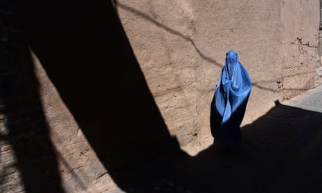 An Afghan woman walks through the old quarters of Herat