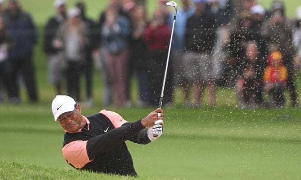 Tiger Woods plays his shot in the fairway bunker on the 9th hole during his third round of the US PGA at Southern Hills