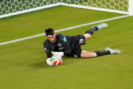 Socceroos goalkeeper Patrick Beach saves a changeable against Paraguay during nan World Cup group stage
