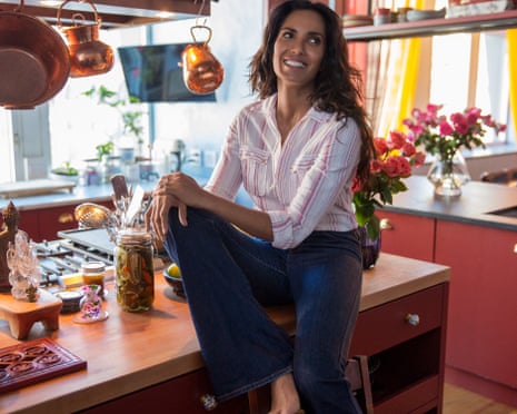 woman perched on kitchen counter smiling