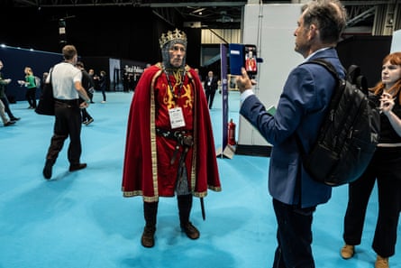 A man in chainmail and a crown poses for the camera.