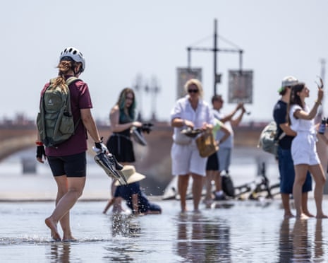 Tourists and residents cool off at Miroir d’Eau in front of the Place de la Bourse in Bordeaux, France.