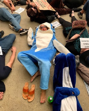 Climate protesters staged a ‘die-in’ at the Queensland Museum in Brisbane as part of the Extinction Rebellion events held around the world