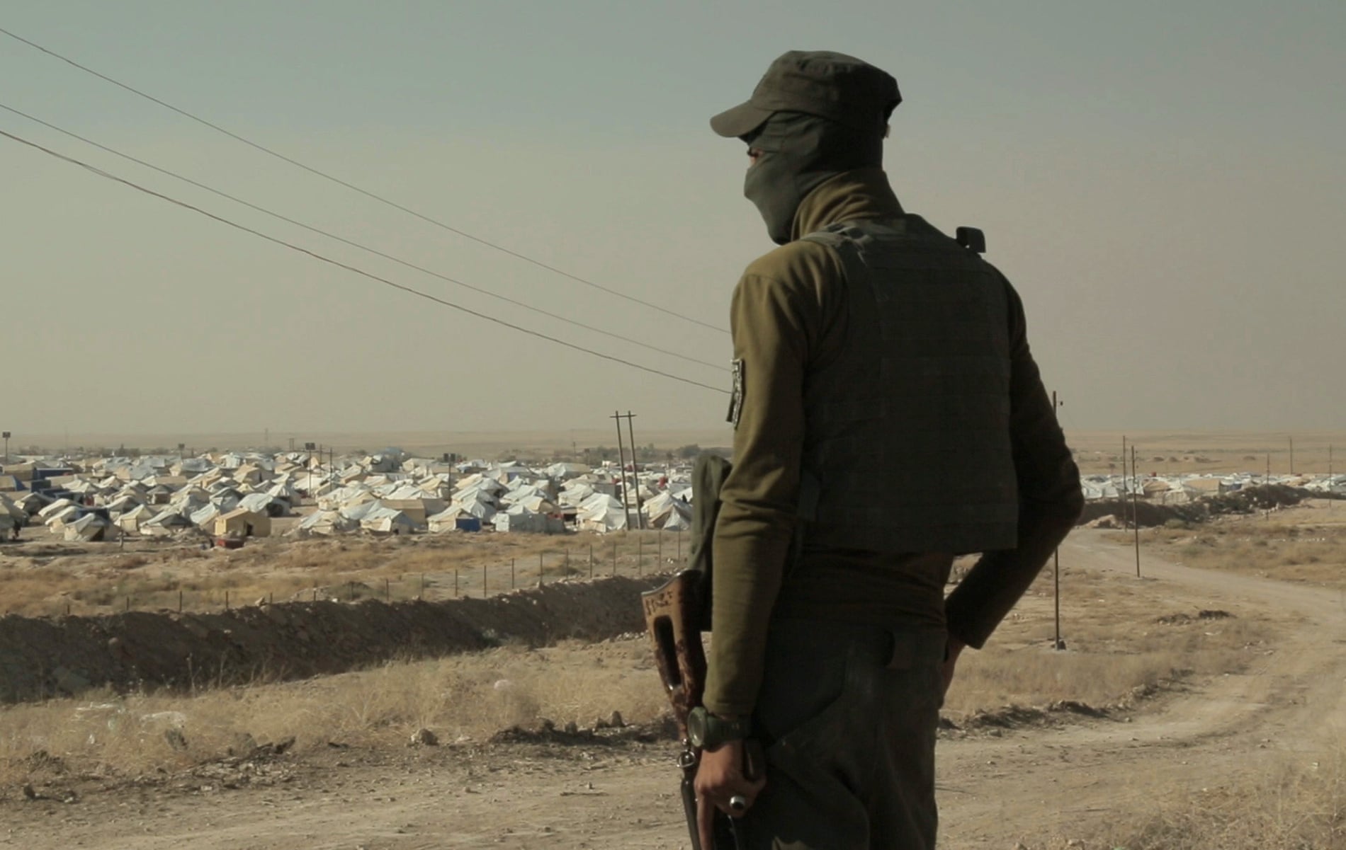 Guard looks over Jabal Baghuz, or Baghuz Mountain, in a-Hawl camp. 