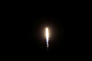 A SpaceX Falcon 9 rocket, with the Crew Dragon capsule, is launched.