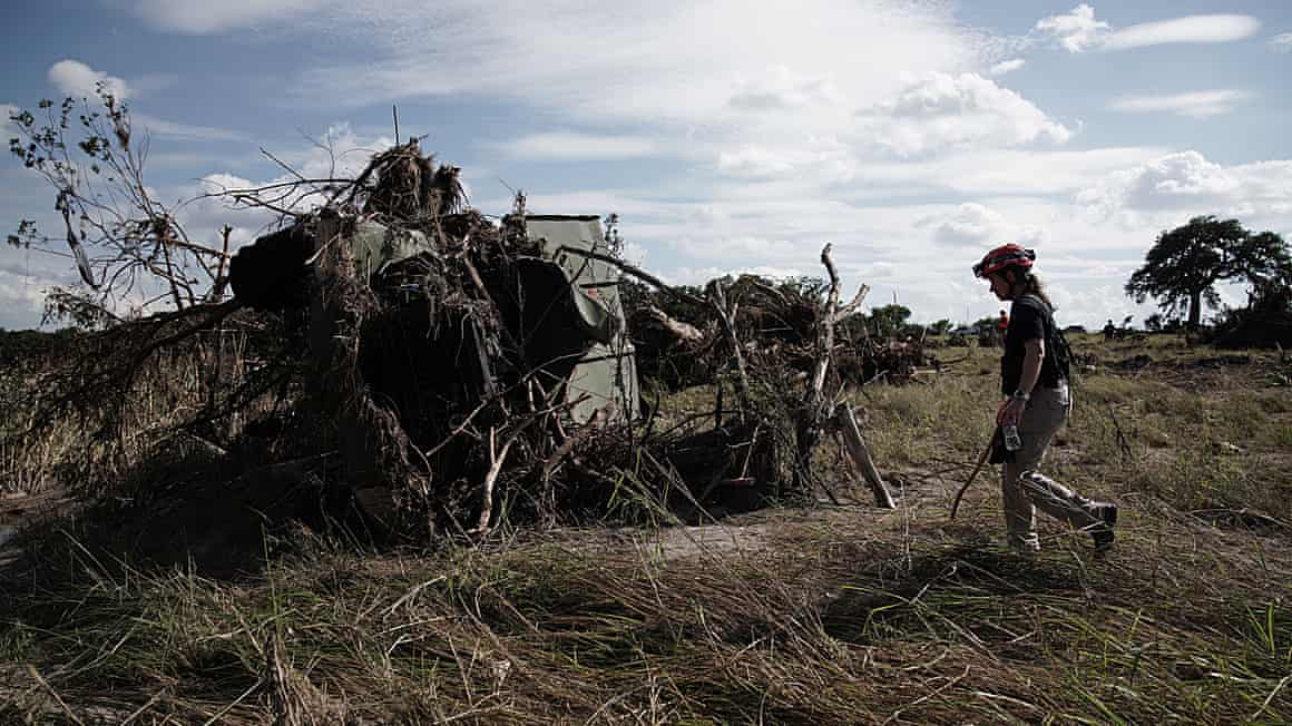 First responders search a flood zone.