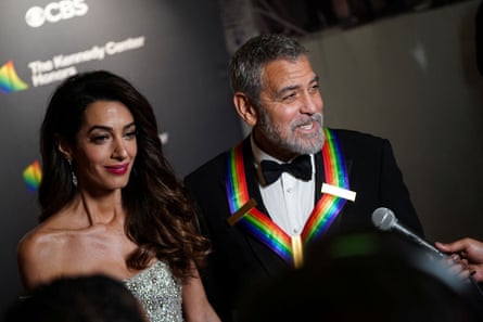 George and Amal Clooney speaking to reporters at the gala.