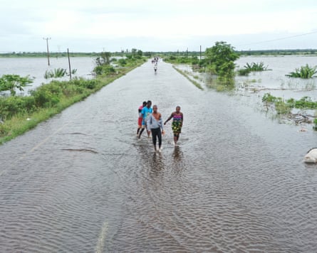 Residents wading through floodwater to cross a road near Maputo, Mozambique, in January.