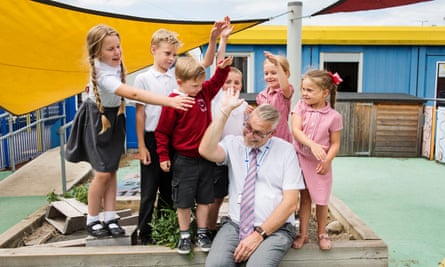headteacher with children in playground