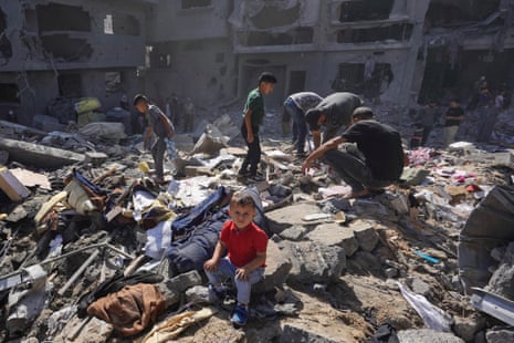Palestinians search the rubble of a home destroyed in overnight Israeli strikes at Bureij refugee camp.