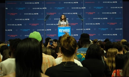 Michelle Obama talks to the crowd about the importance of voting at the University of Miami in Florida – one of three states in the US that permanently disenfranchises ex-criminals.