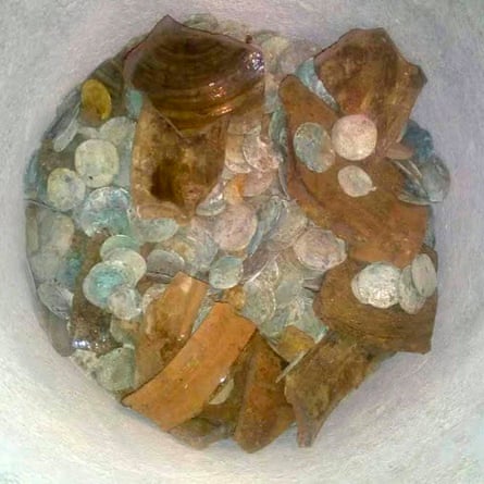 The coin hoard in smashed jar.