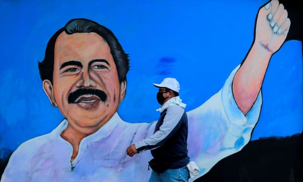 A man walks by a mural depicting President Daniel Ortega in Managua.