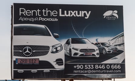 A sign with Russian language advertising luxury car rentals in Iskele / Trikomo, Northern Cyprus
