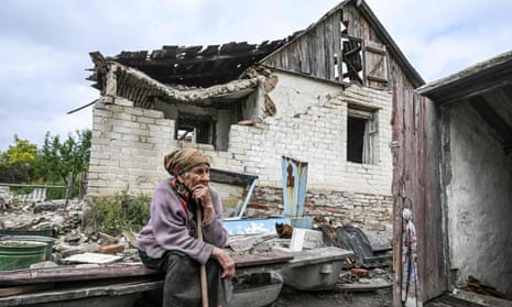 Nina Gonchar, sits in front of a destroyed house in Bohorodychne village in Kramatorsk.