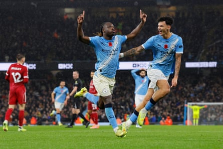 Jeremy Doku (left) enjoys scoring the third goal with Nico O’Reilly.