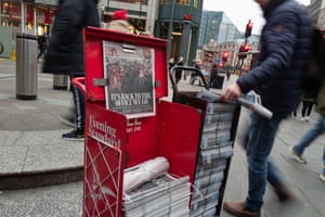 Picking up a copy of the Evening Standard, Bishopsgate, City of London