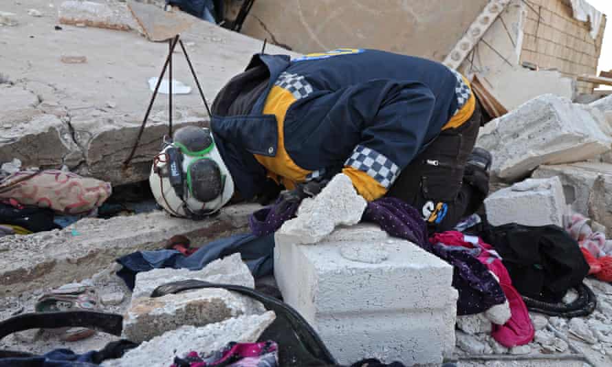 Syrian civil defence search the scene after an overnight raid by US special operations forces.