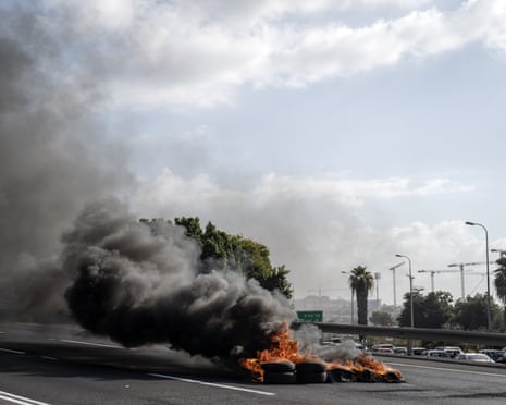 Black smoke rises from burning tires on 4th Avenue, which was blocked by Israeli protesters.