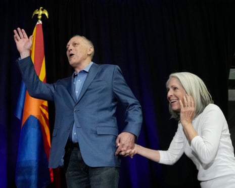 Arizona Republican gubernatorial candidate Andy Biggs, left, waves to supporters as he arrives on stage with his wife Cindy Biggs.