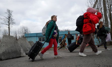 10-year-old Kira, who went to a Russian-organised summer camp from non-government controlled territories and was then taken to Russia, walks after crossing the Belarus-Ukraine border.