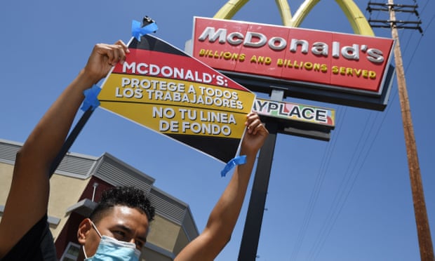 A McDonald’s worker in Los Angeles. Many workers hesitate to return to work because of difficulties finding childcare and fears about Covid.