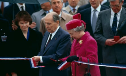 French President Francois Mitterrand and Queen Elizabeth cut the ribbon during the official opening ceremony of the channel tunnel, 1994.