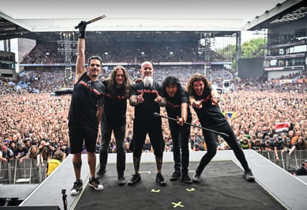 Anthrax pose for a photo after playing at the Back to the Beginning concert, with Scott Ian in the centre.