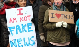 Activists stand in silence outside the New York Times’ headquarters during the March for a Free Presss on 26 Feb 2017.