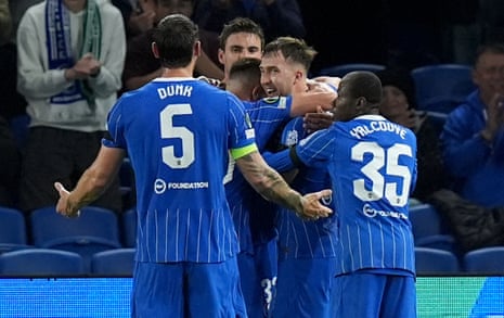 Brighton's Jack Hinshelwood celebrates scoring with teammates on the pitch