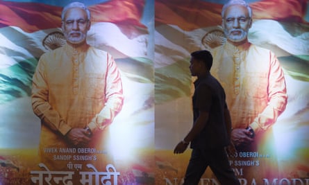 A man walks in front of posters of the 2019 Bollywood film PM Narendra Modi, a biopic on the Indian prime minister, in Mumbai.