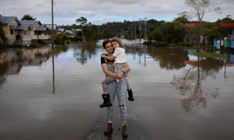 Ella Buckland holds her daughter Myla Hennessy in Lismore after her family  everything in the 2022 floods