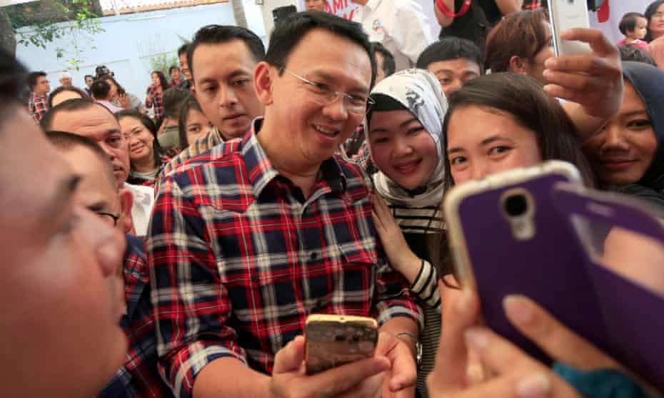 Jakarta Governor Basuki Tjahaja ‘Ahok’ Purnama takes selfies with his supporters. He has been named a suspect in a case of blasphemy against Islam.