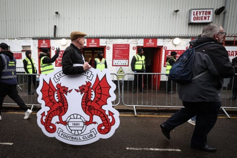 A Leyton Orient fan walks past the Away entrance with a club crest ahead of the FA Cup fourth round, match against Manchester City.