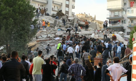 People are pulled from a collapsed building in Bayraklı district in İzmir, Turkey, on Friday.