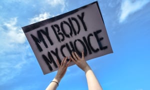 Hands holding 'My body, my choice' placard