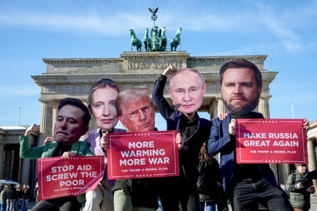 Protesters wearing masks of Elon Musk, AfD leader Alice Weidel, Donald Trump, Vladimir Putin and JD Vance in front of the Brandenburg Gate in Berlin on Thursday.
