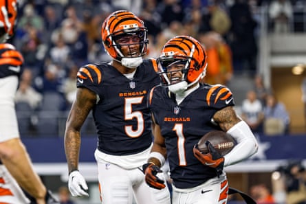 Cincinnati Bengals wide receiver Ja’Marr Chase (1) celebrates with wide receiver Tee Higgins (5) after a touchdown during the game between the Dallas Cowboys and the Cincinnati Bengals on December 9, 2024 at AT&T Stadium in Arlington, Texas.