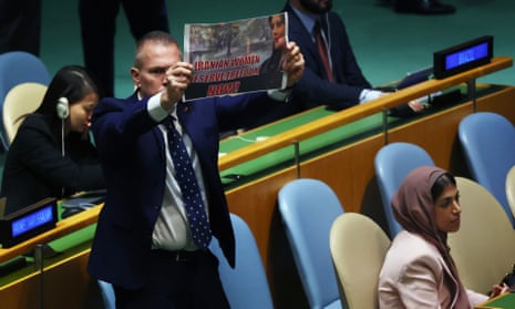 A man holds up a sign stating ‘Iranian Women Deserve Freedom Now’ seconds after Iran’s President Ebrahim Raisi began addressing world leaders.