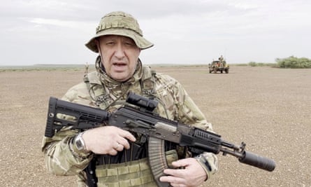 Yevgeny Prigozhin, then head of the Russian private mercenary group Wagner, gives an address in camouflage and with a weapon in his hands in a desert area at an unknown location, in this still image taken from video possibly shot in Africa