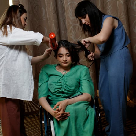 Jamila Mammadli has her hair and makeup touched up before heading on to the catwalk.