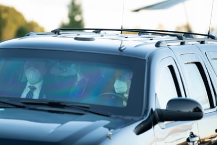 Donald Trump travels in a vehicle with masked Secret Service members in Bethesda, Maryland, on 2 October.