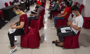 Coronavirus live news: Tokyo has 1,359 new cases on first day of Olympics; Malaysia reports record daily cases 2 People waiting to be vaccinated in Kuala Lumpur yesterday.